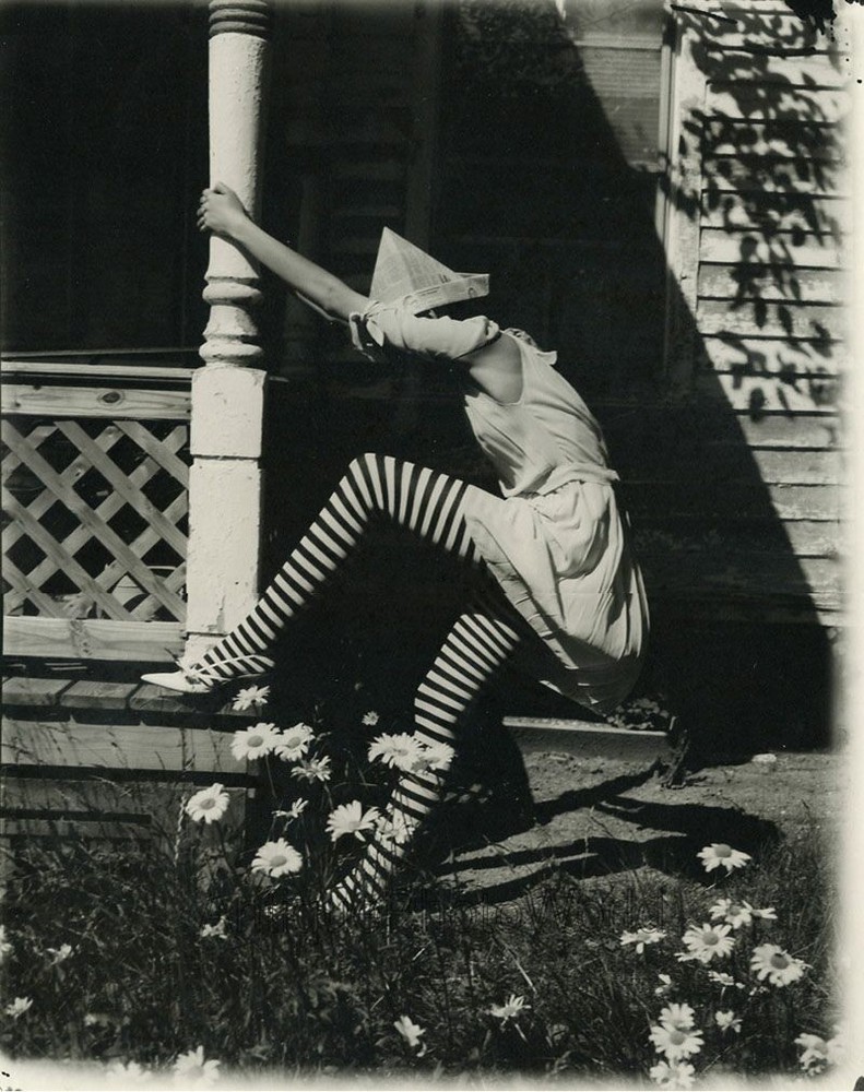 Woman in striped stockings newspaper hat climbing porch strange art large photo