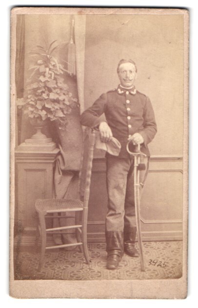 Photograph of a non-commissioned officer in uniform with a saber