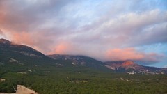 Calm mountains covered with pink clouds